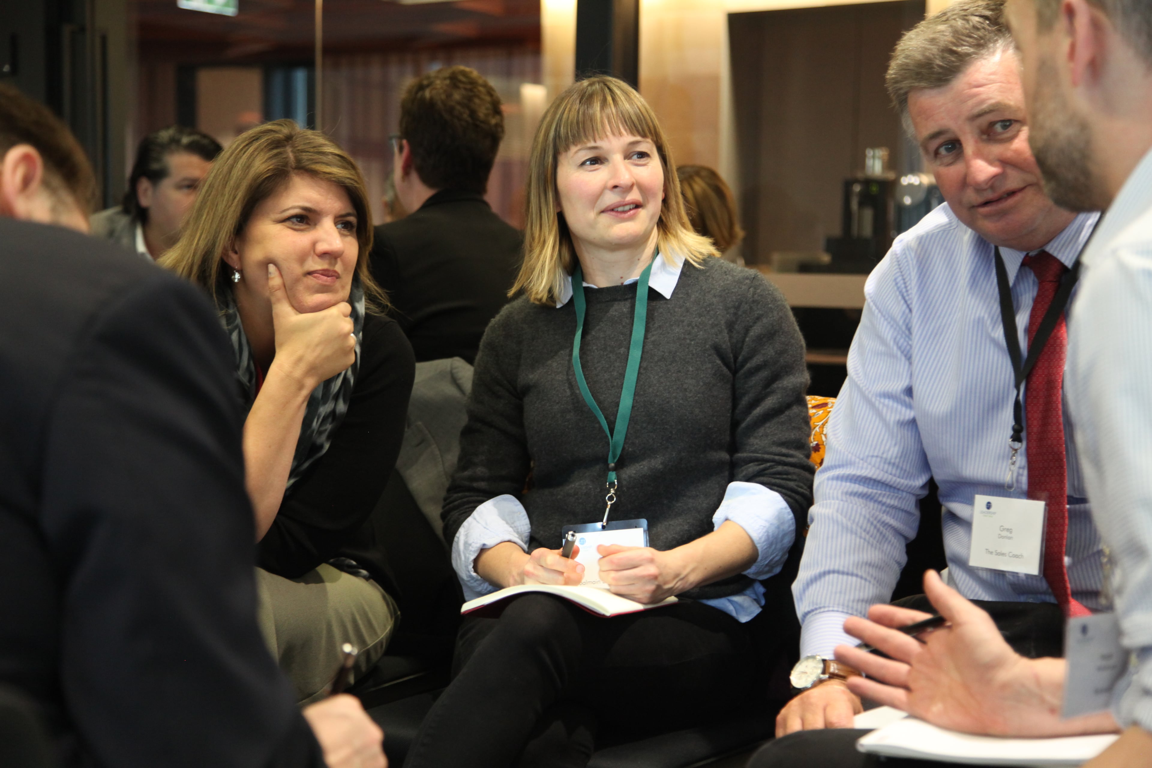 A small group listening closely and taking notes during a Leadership Think Tank conversation